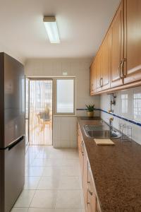 a kitchen with a sink and a counter top at 10 min walk to Rocha Beach in Portimão