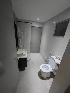 a bathroom with a toilet and a sink at Nicole Homestay in Sitiawan