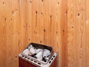 a trash can with rocks in it next to a wooden wall at 6 person holiday home in Juelsminde-By Traum in Sønderby