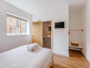a white bedroom with a bed and a window at Ty Felin - Uk12744 in Acrefair +17 photos