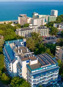 an aerial view of a city with buildings and the ocean at Aphrodite Hotel in Golden Sands