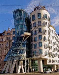 a tall building with a glass building at Angel room with large terrace R6 in Prague