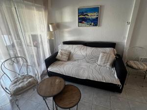 a living room with a couch and a table and chairs at Mini villa Corse du sud Residence U Re D Alzetu in Lecci