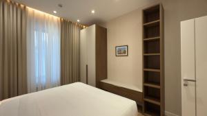 a bedroom with a bed and a book shelf at MK Luxury Serviced Apartment # 2 in Chişinău +21 photos