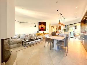 a living room with a couch and a table at Villa Carlina - Saint Tropez in Sainte-Maxime