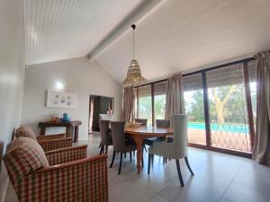 a living room with a dining room table and chairs at Harris Estate Country Home in Ballito