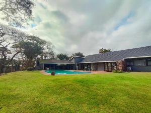 a house with a swimming pool in a yard at Harris Estate Country Home in Ballito