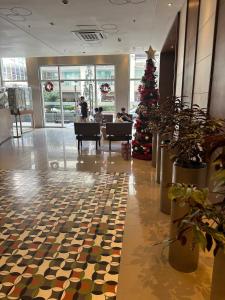 a christmas tree in the middle of a lobby at 2BR Condo in Makati- Good for 6! in Manila +19 photos