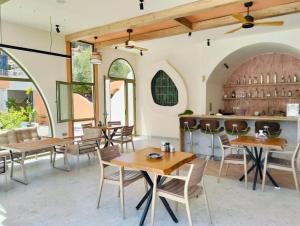 a dining room with tables and chairs and windows at Lina Life in Fethiye