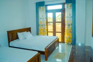 Katil atau katil-katil dalam bilik di Nimala Holiday Homes