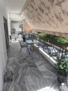 a view of a patio with tables and chairs at Sole Apartment Xanthi in Xanthi