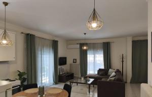 a living room with a couch and a table at Sole Apartment Xanthi in Xanthi