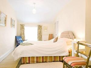 a bedroom with a white bed and a window at Church Lane in Llanidloes