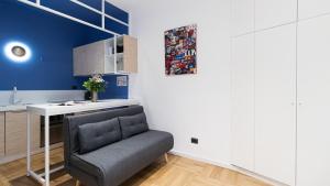 a living room with a chair and a desk at Italianway - Porta Ticinese 78 B in Milan