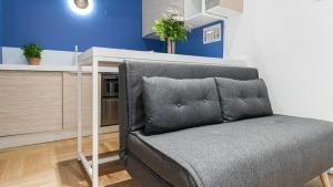 a couch in a living room with a table at Italianway - Porta Ticinese 78 B in Milan