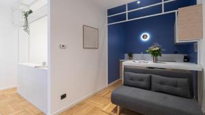 a living room with a couch and a blue wall at Italianway - Porta Ticinese 78 B in Milan
