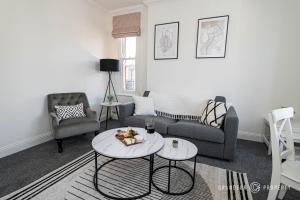 a living room with a couch and a table at The Westborough Nook by Grandeur Property in Wimborne Minster