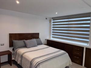 a bedroom with a bed and a large window at Xalapa Monte Novo Contemporary House in Xalapa