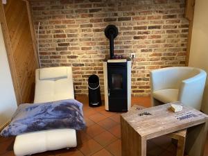 a living room with two chairs and a wood stove at Retreat with Private Garden in Güntersberge +32 photos