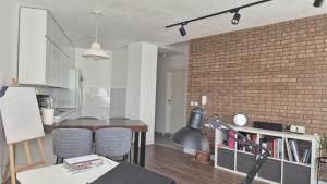 a kitchen and dining room with a brick wall at odmor i rabota vo centar in Kočani +3 photos
