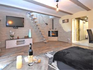 a living room with a staircase and a tv at Garden Escape in Wernigerode in Wernigerode