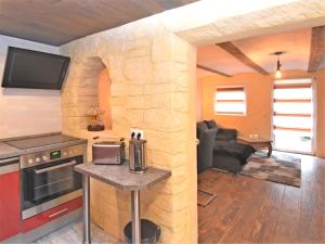 a kitchen and living room with a stone wall at Garden Escape in Wernigerode in Wernigerode +26 photos