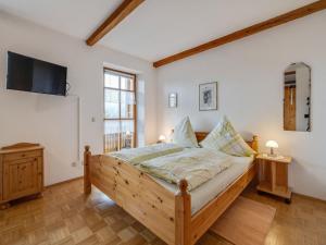 a bedroom with a bed and a flat screen tv at Wohnung in Lohberg nahe Arber Skipisten in Schwarzenbach