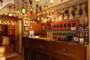 a bar in a pub with lights on the wall at Kybele Hotel in Istanbul