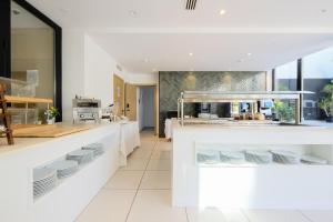 a kitchen with white counters and white plates on display at M. HOTEL in San Antonio