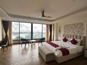 a bedroom with a large bed and a large window at Yasa Retreat in Tādong +25 photos