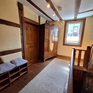 a living room with a refrigerator and a window at Ferienwohnung Schlossstrasse 7 in Steinbach