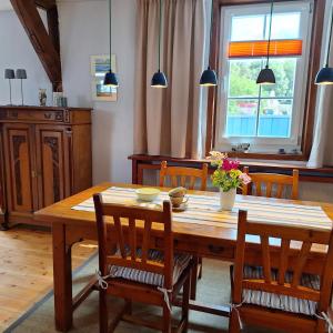 a dining room with a wooden table and chairs at Ferienwohnung Schlossstrasse 7 in Steinbach