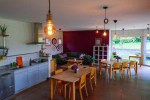 a kitchen and a living room with a table and chairs at Ostello Cresciano in Cresciano +21 photos