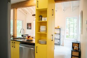a kitchen with yellow cabinets and a sink at Country Comfort - Woods & RiverLa Sittelle in Saint-Raymond +47 photos
