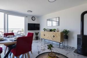 a living room with a table and a fireplace at Villa Romana in Bibinje