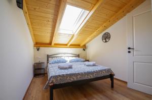 a bedroom with a bed with a skylight at Villa Romana in Bibinje +47 photos