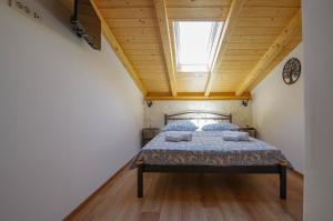 a bedroom with a bed with a skylight at Villa Romana in Bibinje +38 photos