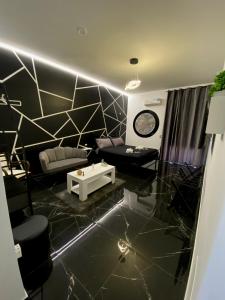 a living room with a couch and a table at Syràkousai Prestige in Syracuse