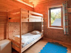 Letto a castello in una baita di tronchi con finestra di Villa in Freyneux with Garden a Freineux