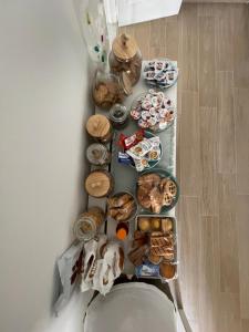 a table with many different types of food on it at A Casa dei Miei - camere in centro in Otranto