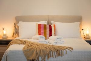 a bedroom with a bed with towels on it at Seaside Breeze Studio in Agios Nikolaos +6 photos