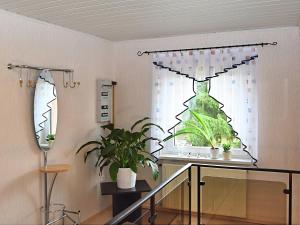 a window with a potted plant in a room at Ruhiges Ferienhaus in Floh-Seligenthal in Seligenthal +12 photos
