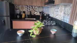 a kitchen with a counter with three bowls on it at Barranquilla Dreams in Puerto Colombia