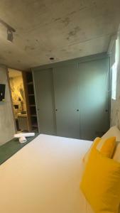 a bedroom with a large white bed with yellow pillows at Barranquilla Dreams in Puerto Colombia +61 photos