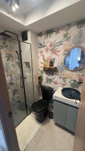 a bathroom with a shower and a toilet and a sink at Barranquilla Dreams in Puerto Colombia