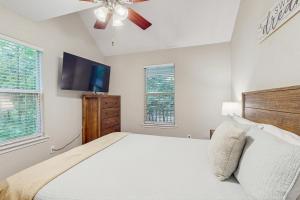 a bedroom with a bed and a ceiling fan at Laurel Creek in Helen +22 photos