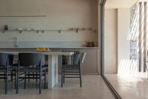 a kitchen with a table and black chairs at Alykes Villa - Seaview escape in Plakias