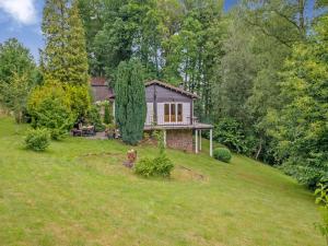 a small house on a hill in a yard at Cozy Hideaway in Ferrières in Ferrières +32 photos