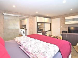 a bedroom with a bed with a red blanket on it at Ferienwohnung Christina in Friedrichroda in Friedrichroda +29 photos
