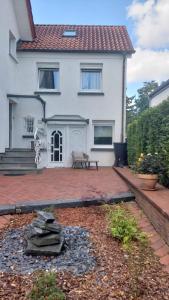 a house with a brick patio in front of it at Zimmer mit eigenem Bad und eigenem Eingang in Bad Oeynhausen +4 photos